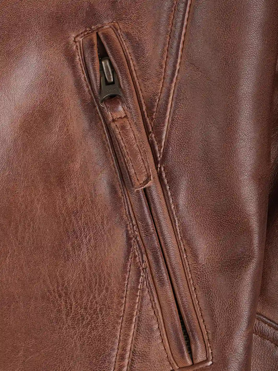 Close-up of a brown leather jacket with a zipper